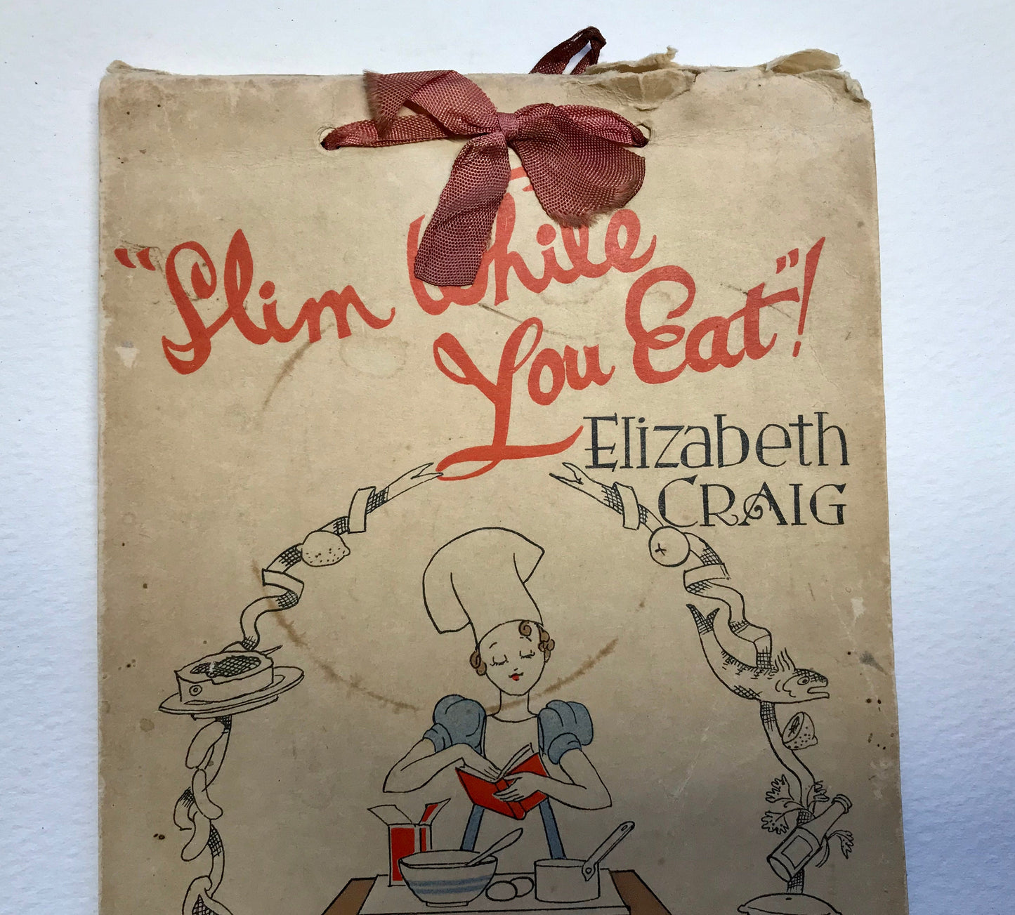 Slim While You Eat! A Calendar with over 100 Recipes. By Elizabeth Craig. Published by G. Delgado Ltd in 1940. 21 x 14 cms. A rare book.
