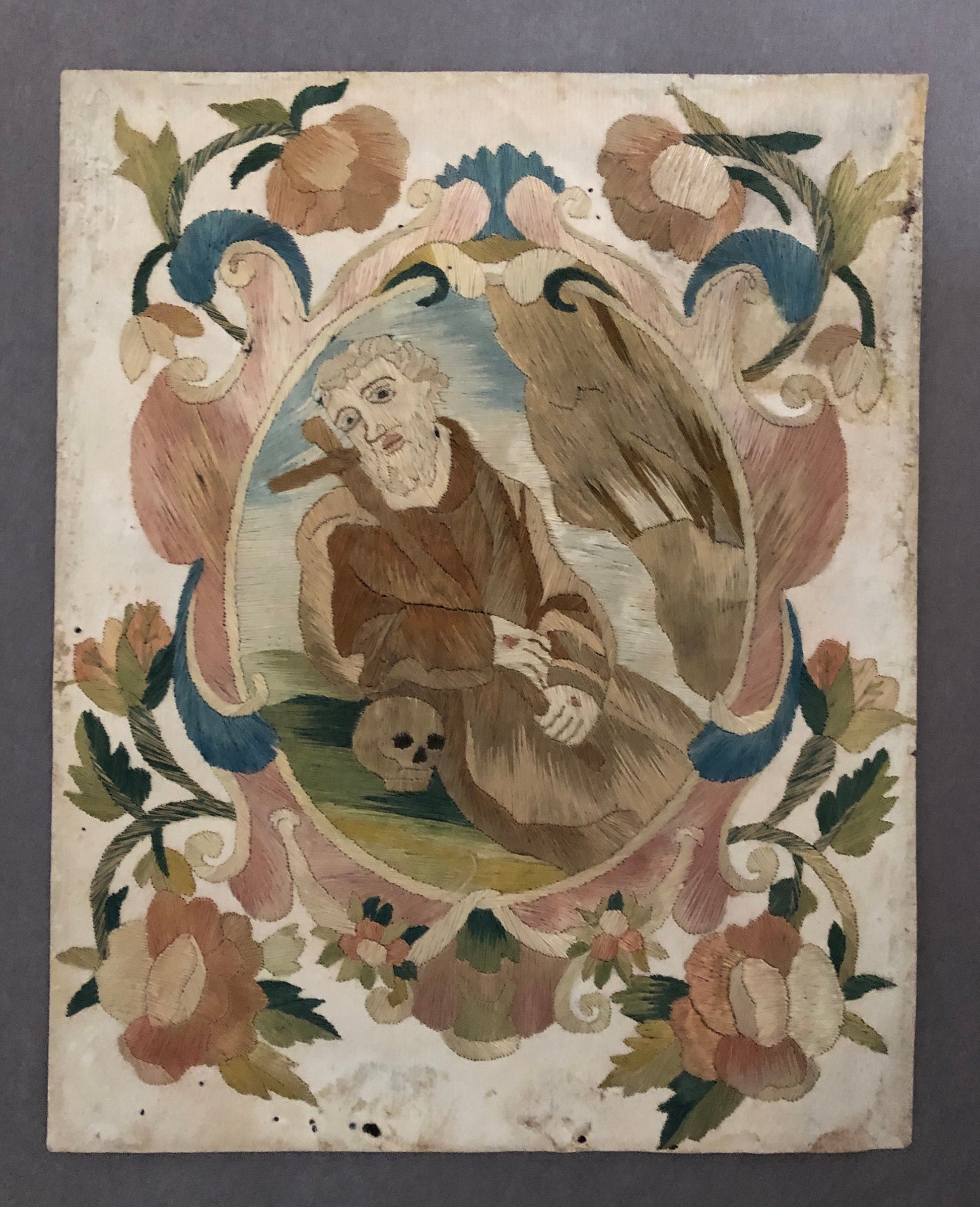 A Fine Silk Double Sided Embroidery of a Saint, Possibly St. Francis, With Skull and Stigmata. French 17th Century. 20 x 16 cms.