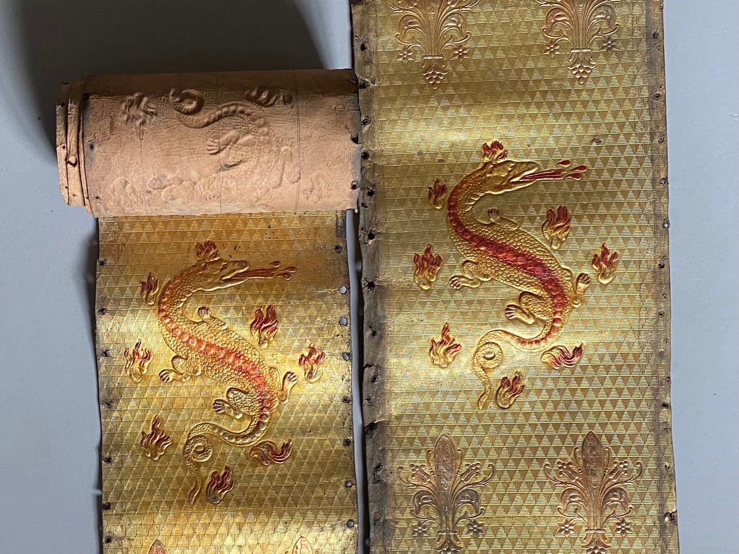 Two Long Lengths of Gilded Antique Leather Decorated With Bronze Dragons and Siver Fleur de Lis. French. Size: 9.5 meters in length.