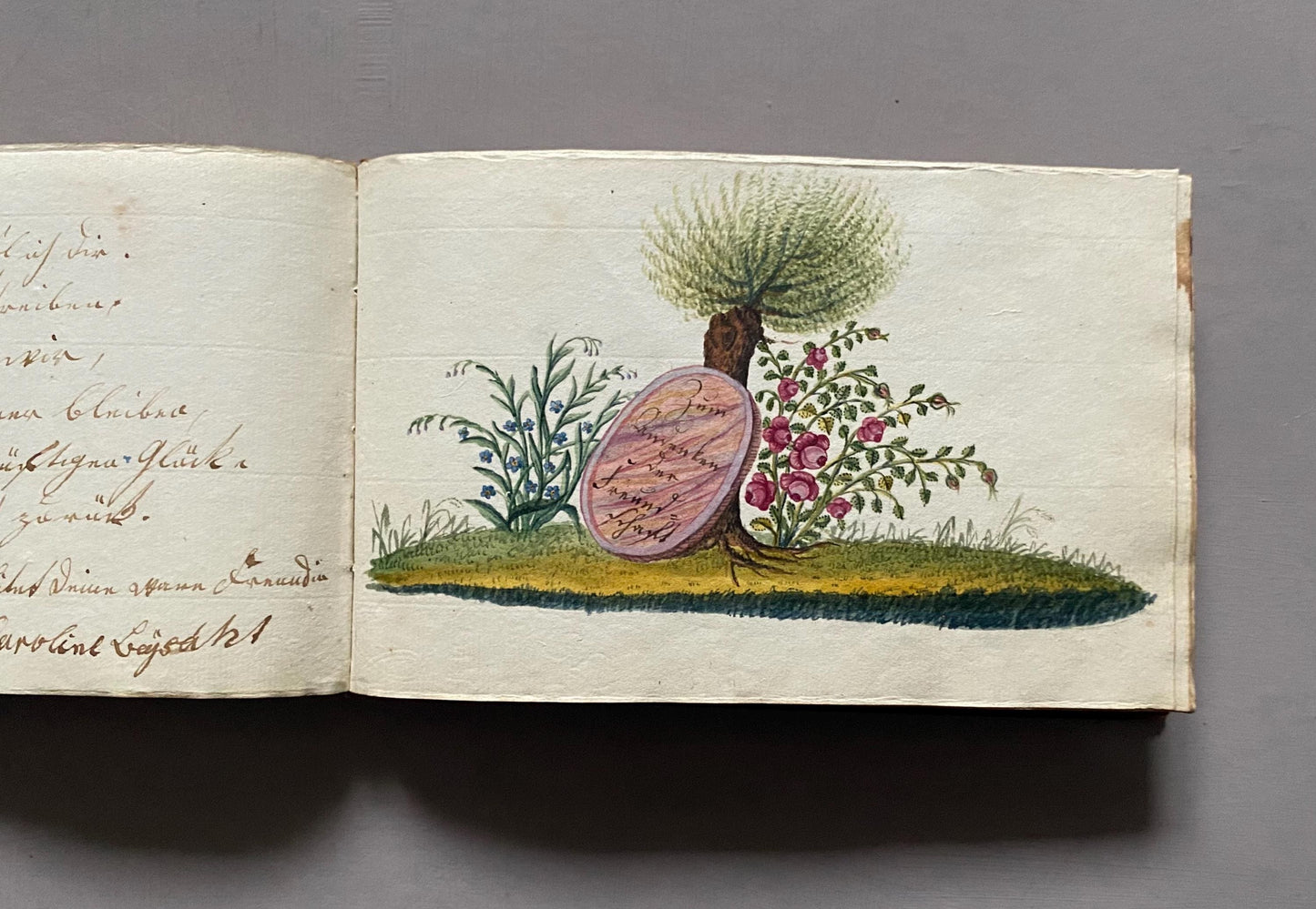A Leatherbound Autograph Book Containing 5 Watercolours and A Needlework Posy. German. Early 1800s. Size: 12 x 18.5 cms.