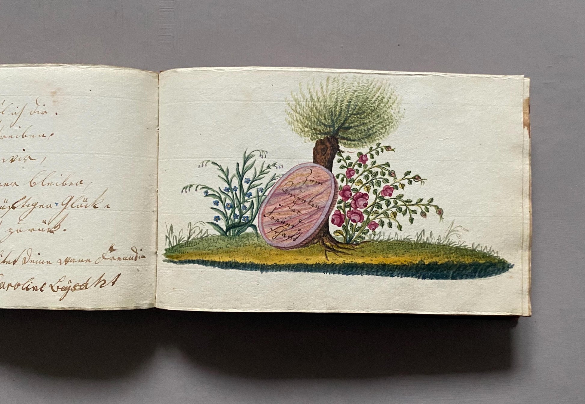 A Leatherbound Autograph Book Containing 5 Watercolours and A Needlework Posy. German. Early 1800s. Size: 12 x 18.5 cms.