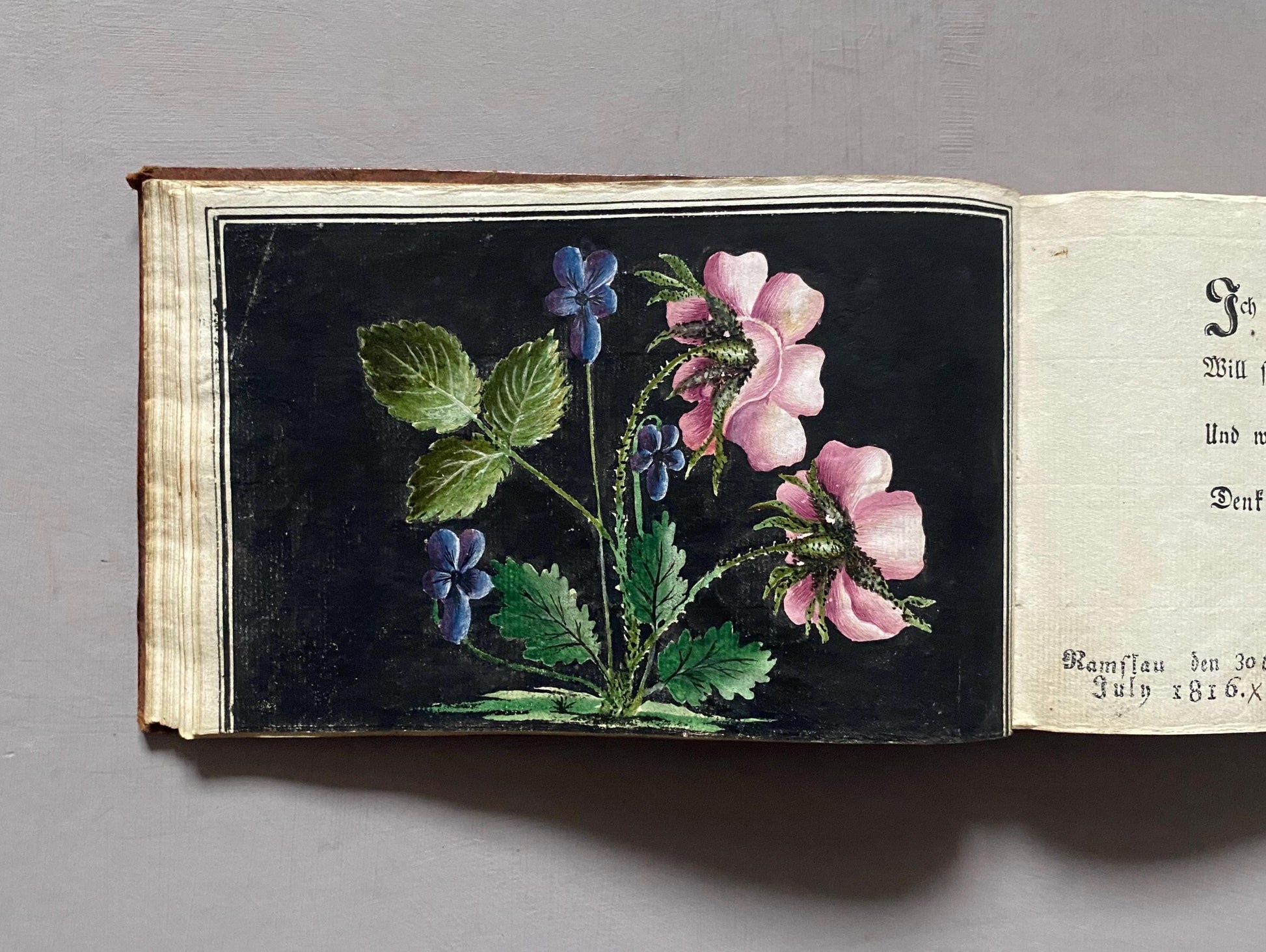 A Leatherbound Autograph Book Containing 5 Watercolours and A Needlework Posy. German. Early 1800s. Size: 12 x 18.5 cms.