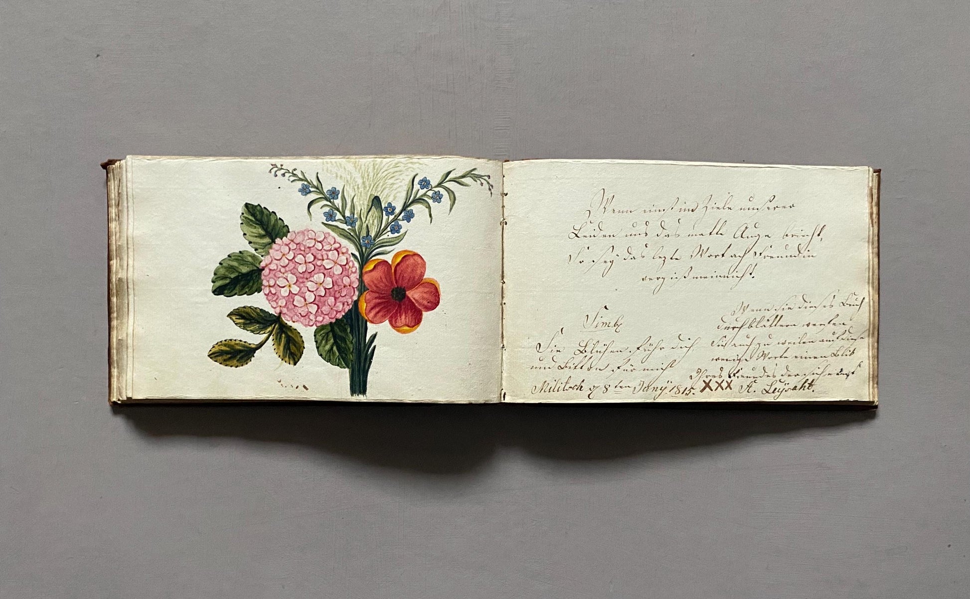 A Leatherbound Autograph Book Containing 5 Watercolours and A Needlework Posy. German. Early 1800s. Size: 12 x 18.5 cms.