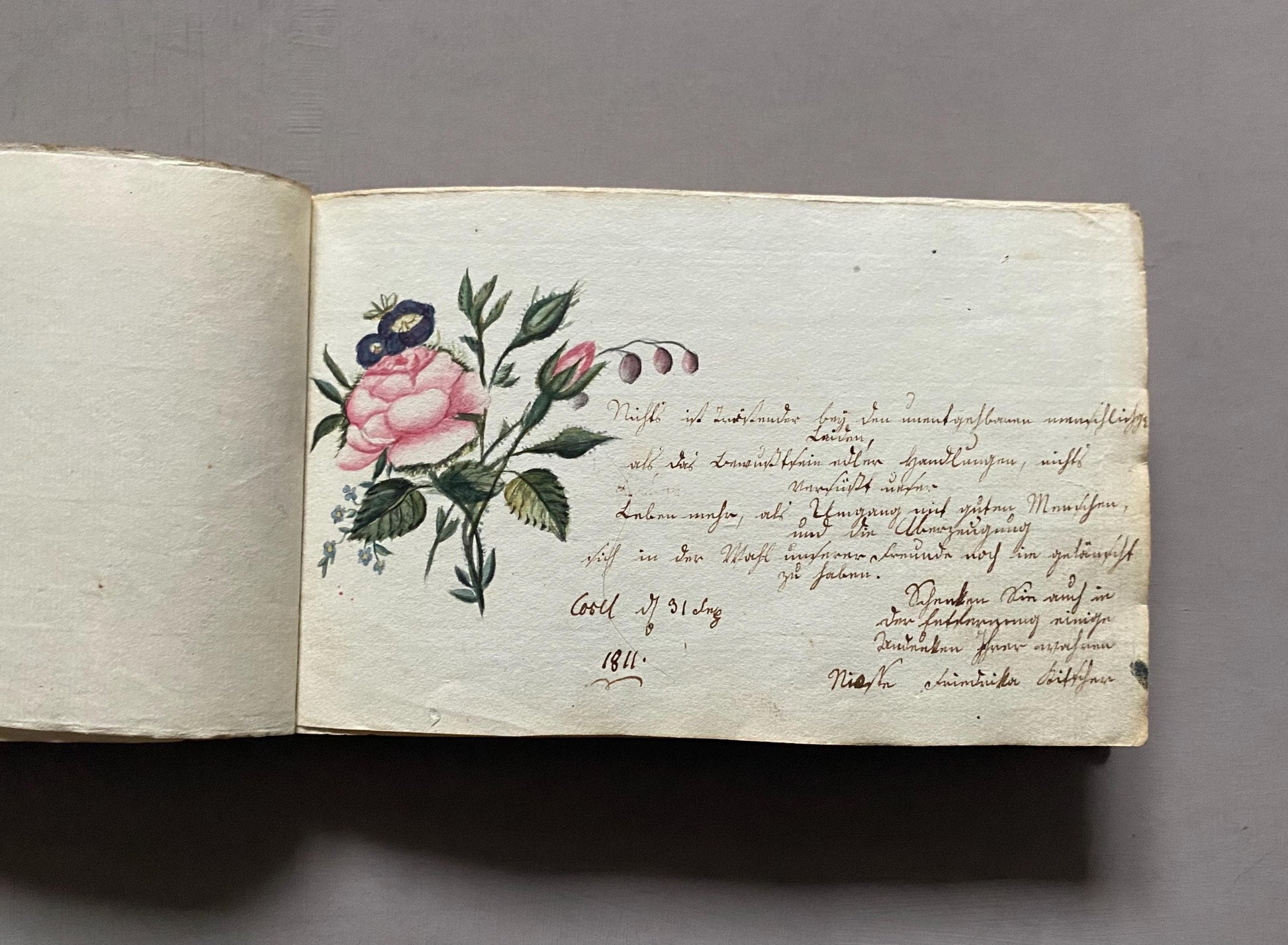 A Leatherbound Autograph Book Containing 5 Watercolours and A Needlework Posy. German. Early 1800s. Size: 12 x 18.5 cms.