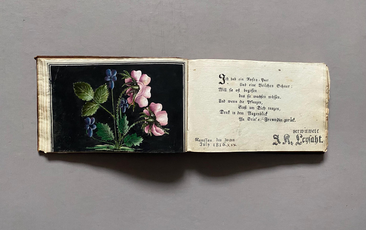 A Leatherbound Autograph Book Containing 5 Watercolours and A Needlework Posy. German. Early 1800s. Size: 12 x 18.5 cms.