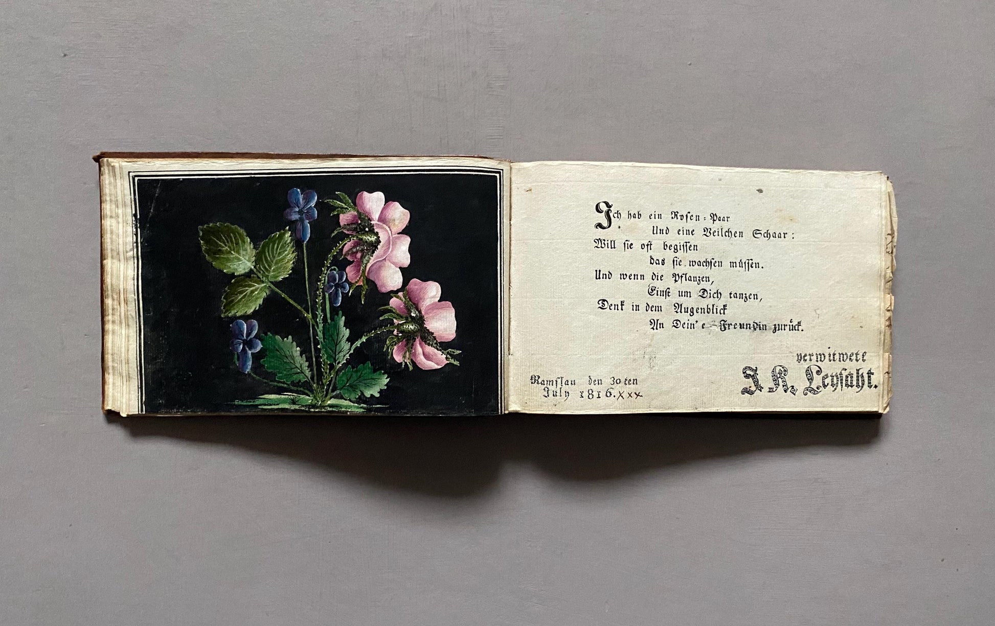 A Leatherbound Autograph Book Containing 5 Watercolours and A Needlework Posy. German. Early 1800s. Size: 12 x 18.5 cms.