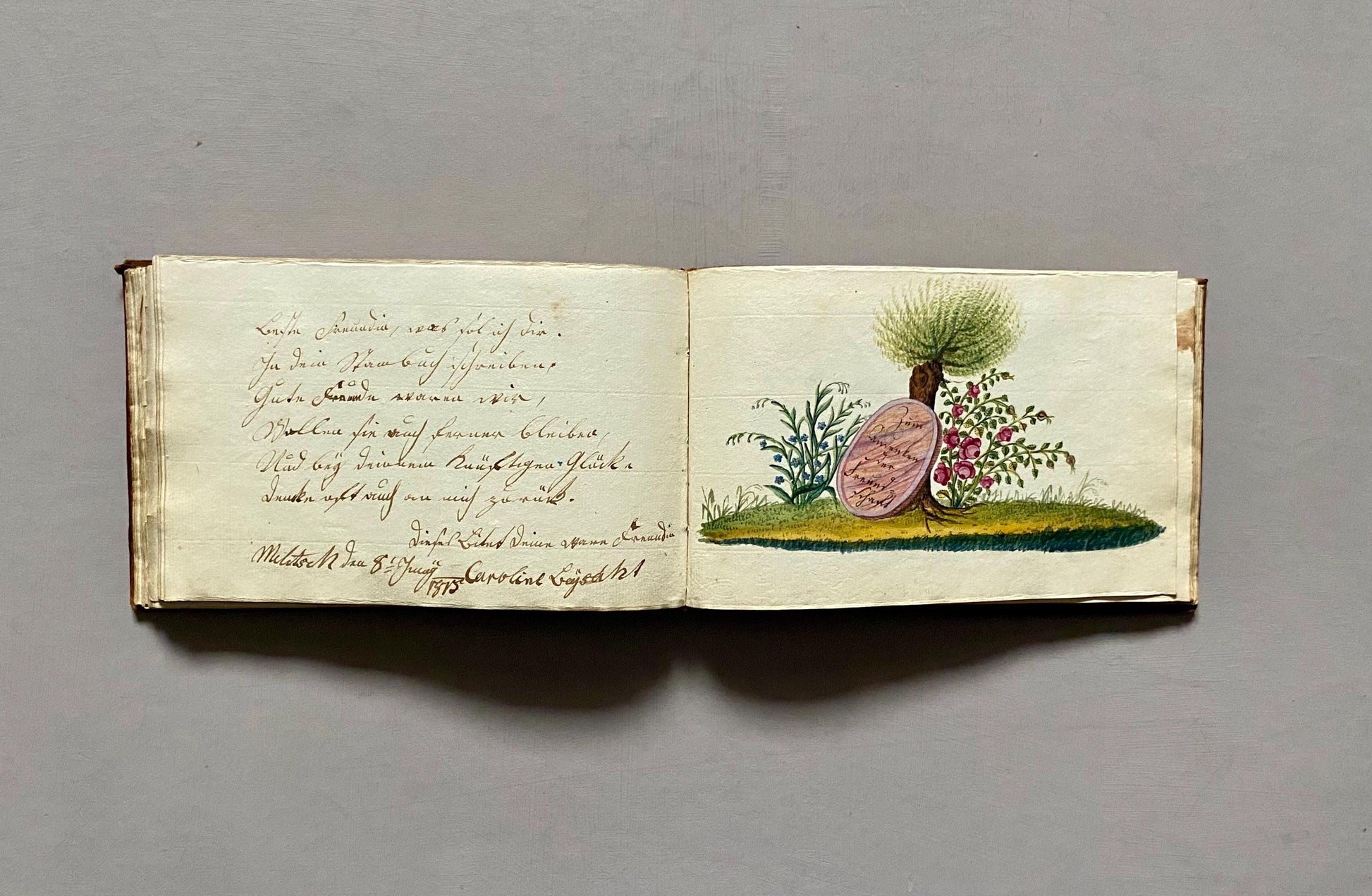 A Leatherbound Autograph Book Containing 5 Watercolours and A Needlework Posy. German. Early 1800s. Size: 12 x 18.5 cms.