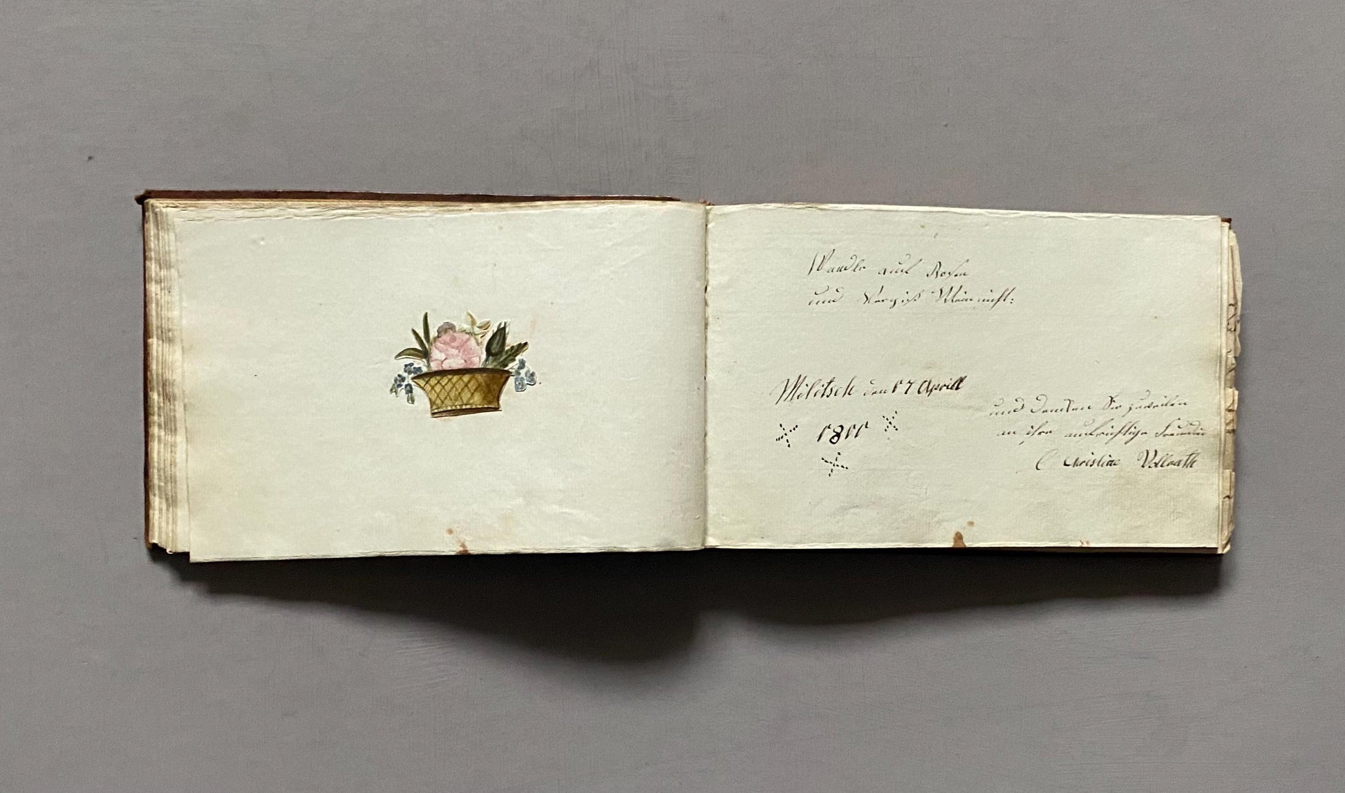A Leatherbound Autograph Book Containing 5 Watercolours and A Needlework Posy. German. Early 1800s. Size: 12 x 18.5 cms.