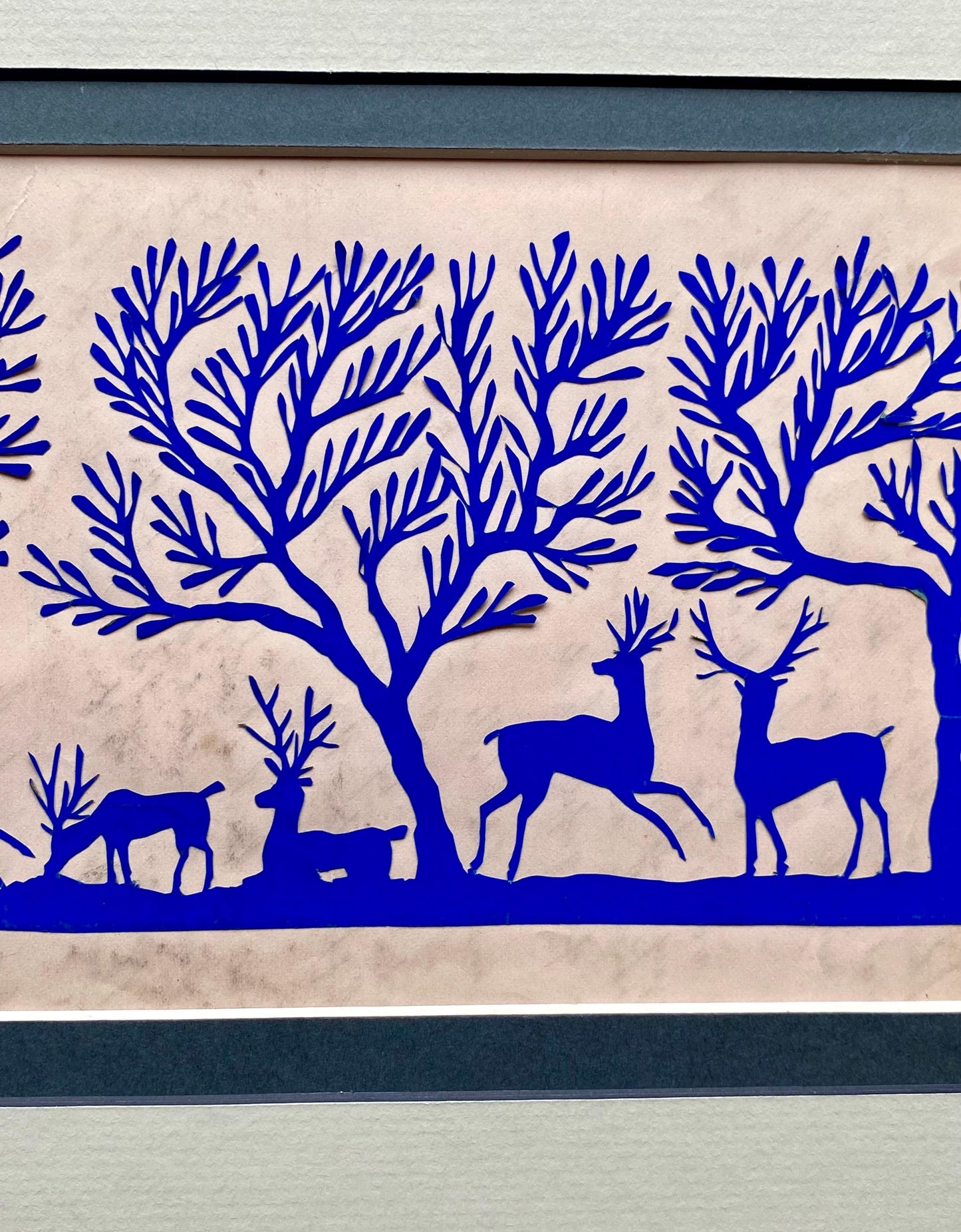 An Antique Paper Cut. Deer In a Wood. Blue on a Pale Pink Ground. Late Georgian, Early Victorian. Size: 12.7 x 21.5 cms.