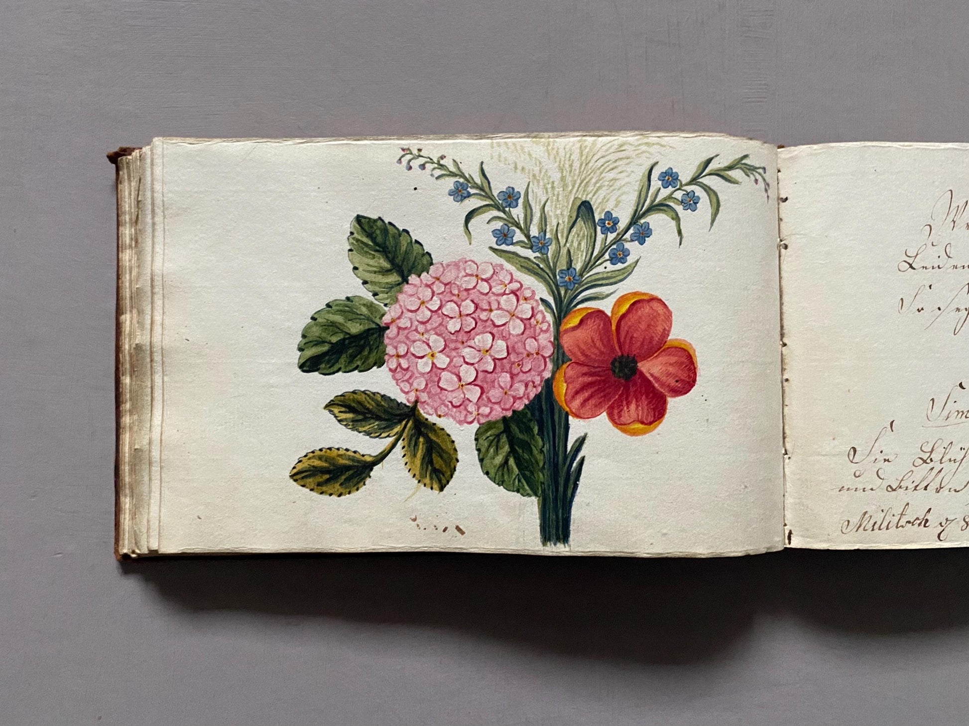 A Leatherbound Autograph Book Containing 5 Watercolours and A Needlework Posy. German. Early 1800s. Size: 12 x 18.5 cms.