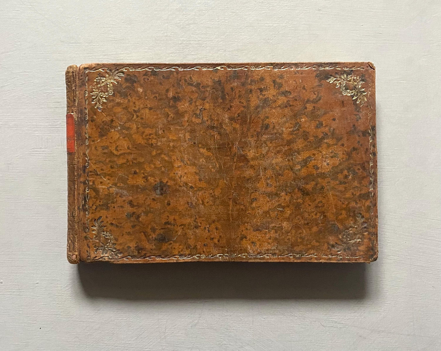 A Leatherbound Autograph Book Containing 5 Watercolours and A Needlework Posy. German. Early 1800s. Size: 12 x 18.5 cms.