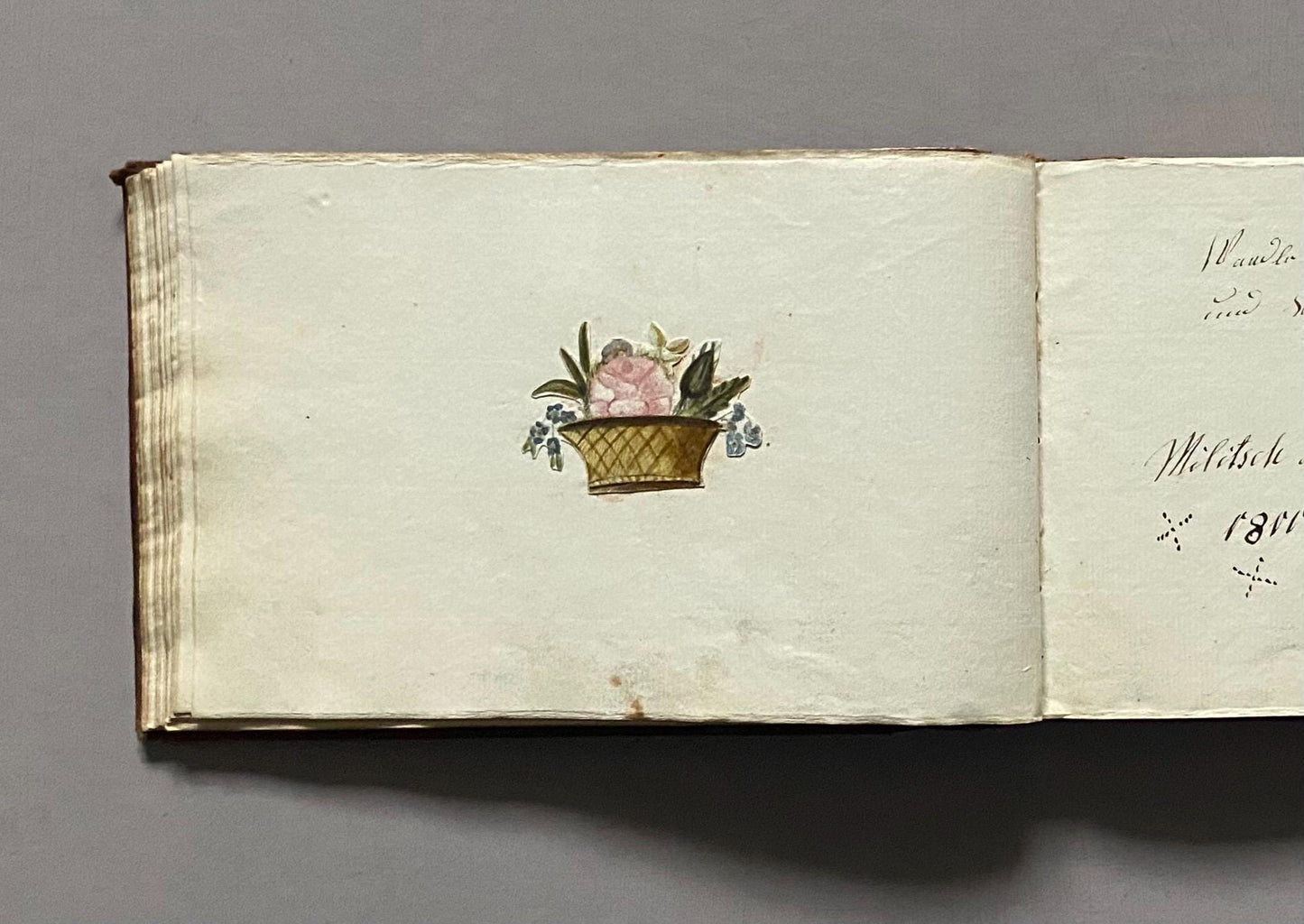 A Leatherbound Autograph Book Containing 5 Watercolours and A Needlework Posy. German. Early 1800s. Size: 12 x 18.5 cms.
