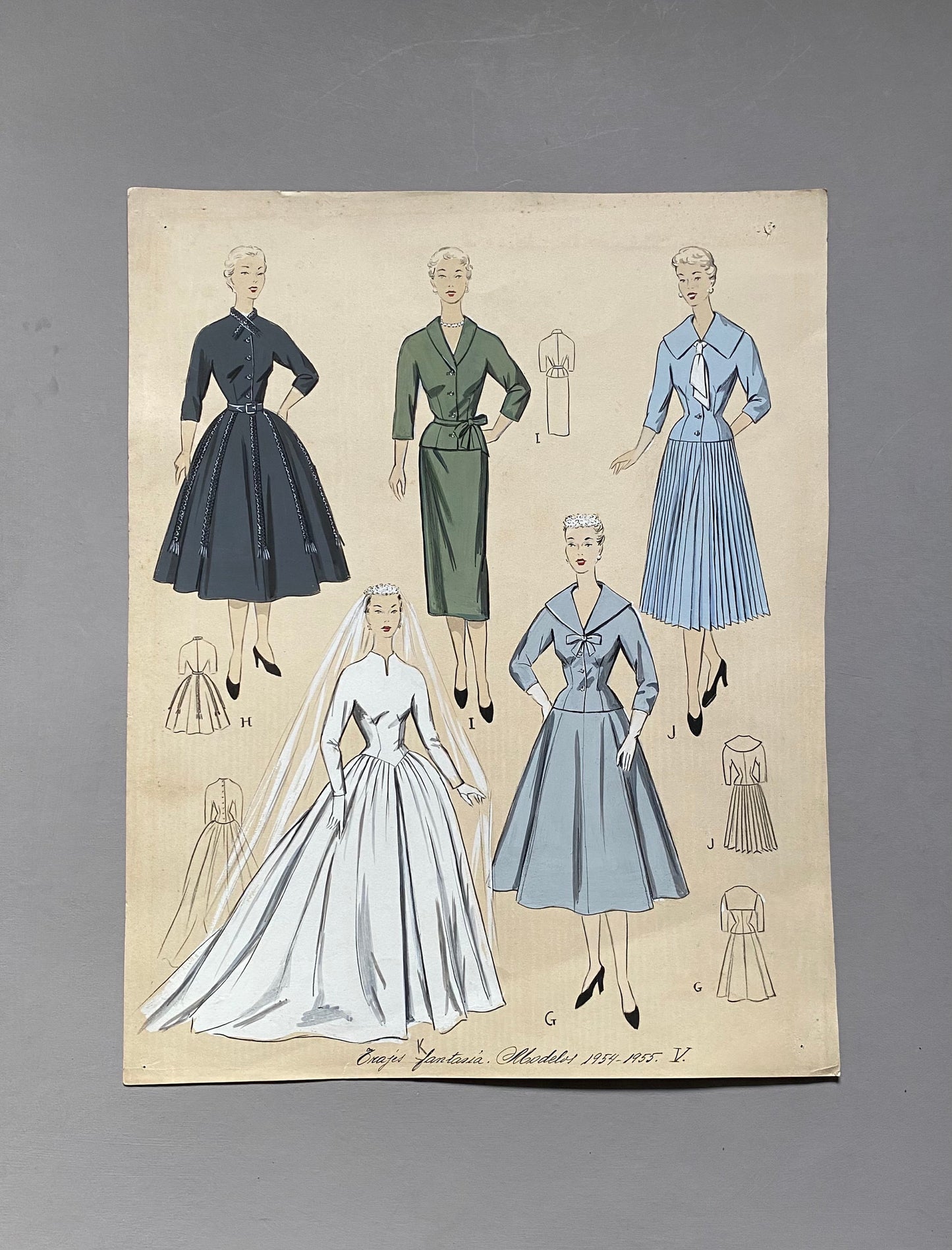 May include: A vintage fashion illustration featuring five different dress designs. The illustration is in black, white, green, blue, and light blue. The text at the bottom reads "Croquis Fantasia Modeles 1957-1957-V."