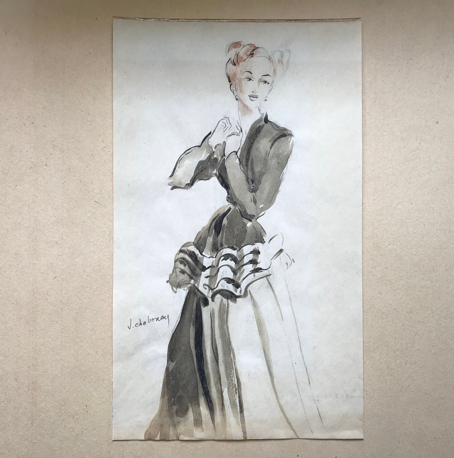 May include: A black and white ink drawing of a woman wearing a black dress with a ruffled skirt. The woman has her hair pulled back in a bun and is wearing a simple necklace. The drawing is signed "J. Chobanay" in the bottom left corner.