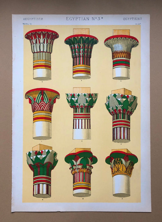 May include: A vintage illustration of nine different Egyptian column capitals. The capitals are painted in various colors, including red, green, yellow, and white. The illustration is titled "Egyptian No. 3*" and is from a book titled "Aegyptisch Tafel VI".