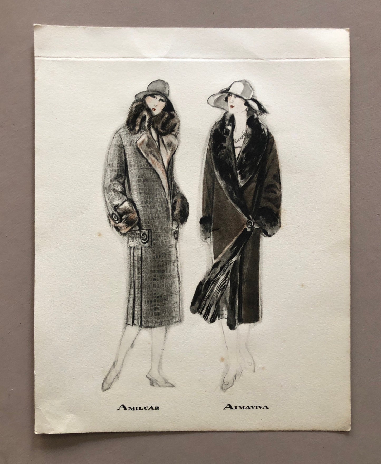May include: A black and white illustration of two women wearing fur-trimmed coats. The woman on the left is wearing a gray coat with a brown fur collar and cuffs. The woman on the right is wearing a black coat with a black fur collar and cuffs. Both women are wearing hats. The text "Amilcar" and "Almaviva" is printed below the women.