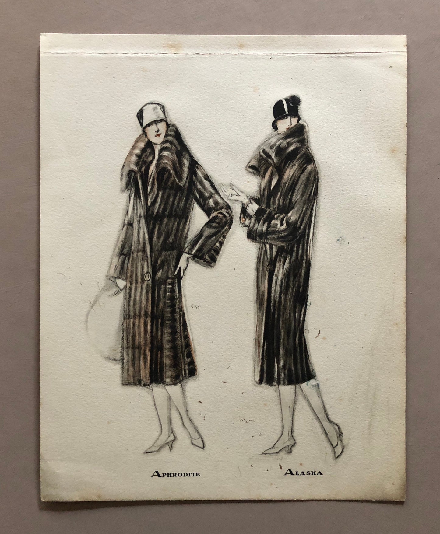 May include: A black and white illustration of two women wearing fur coats. The woman on the left is labeled "APHRODITE" and the woman on the right is labeled "ALASKA".
