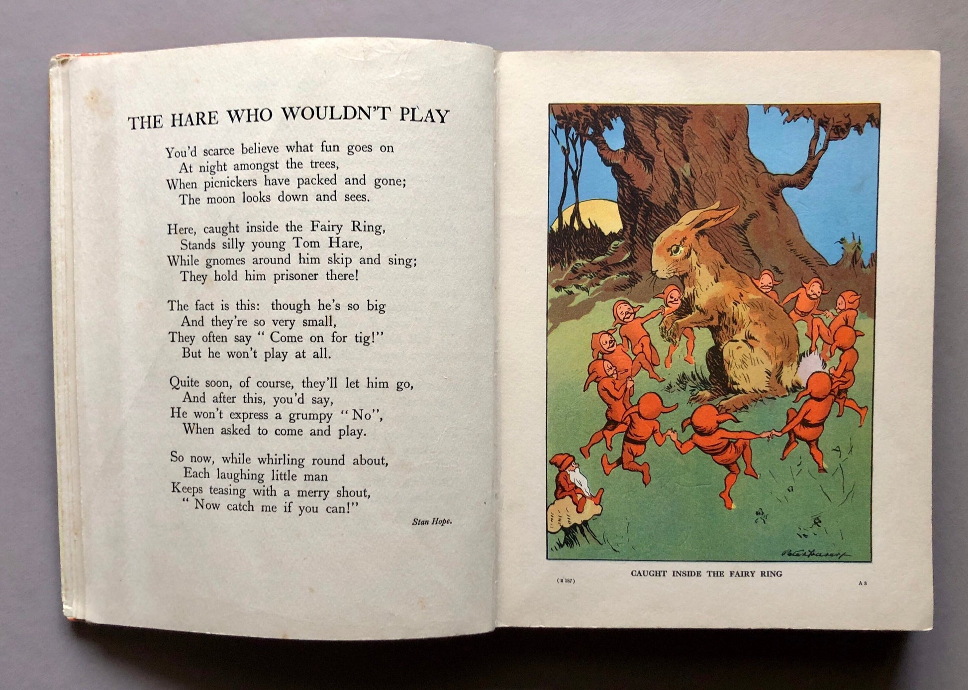May include: An illustration from a children's book depicting a brown hare surrounded by small, red gnomes. The hare is caught inside a fairy ring, and the gnomes are dancing around it. The text reads "The Hare Who Wouldn't Play" and "Caught Inside the Fairy Ring."
